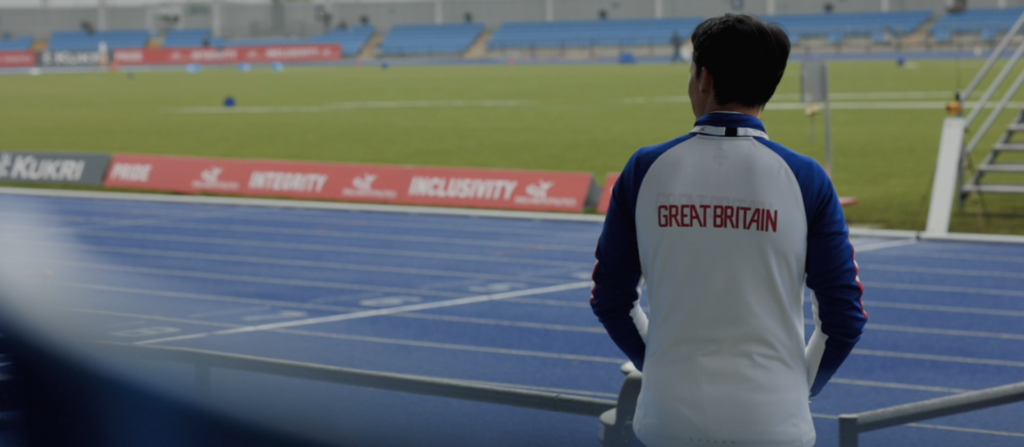 Man stares out at pitch at England Athletics event